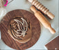 Child using Kinfolk Gumnut Leaf dough cutter with eco-friendly tools and materials on a wooden board.