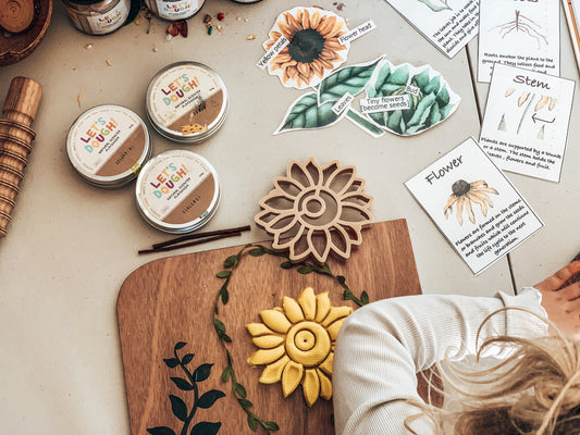 Eco Dough Cutter - Sunflower on a wooden board with educational cards and non-toxic dough, promoting sustainable play.