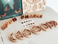 Eco dough cutters in moon phase design, educational play set, non-toxic, sustainable materials, and graphics card for gift ideas.